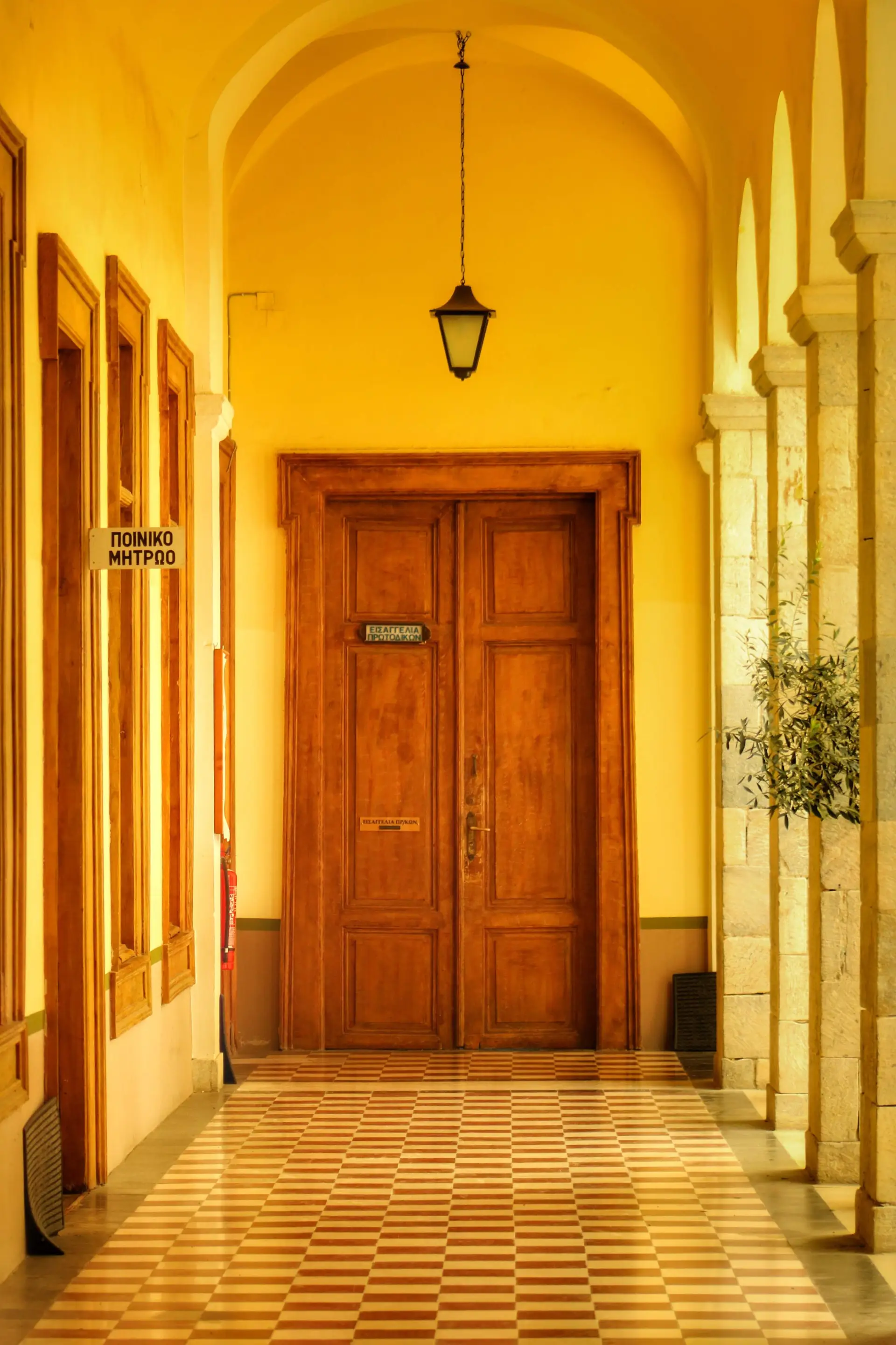 Sunlit timber doorway in a quietly detailed Mediterranean-inspired interior