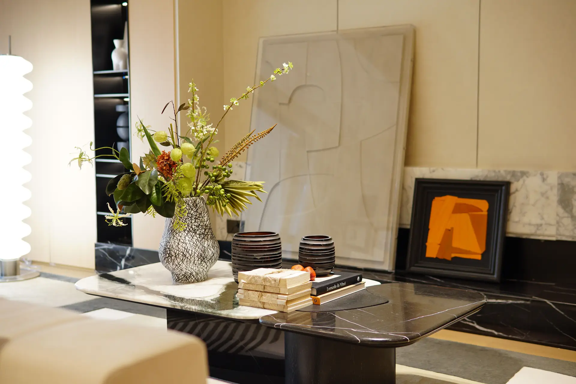 Honed marble table with hand-thrown ceramic vessels and sculptural branch