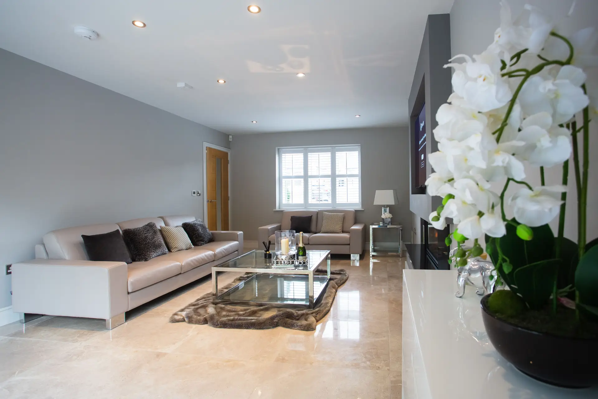 Architectural interior detail of modern living room with floral focal piece and sculptural bronze elements