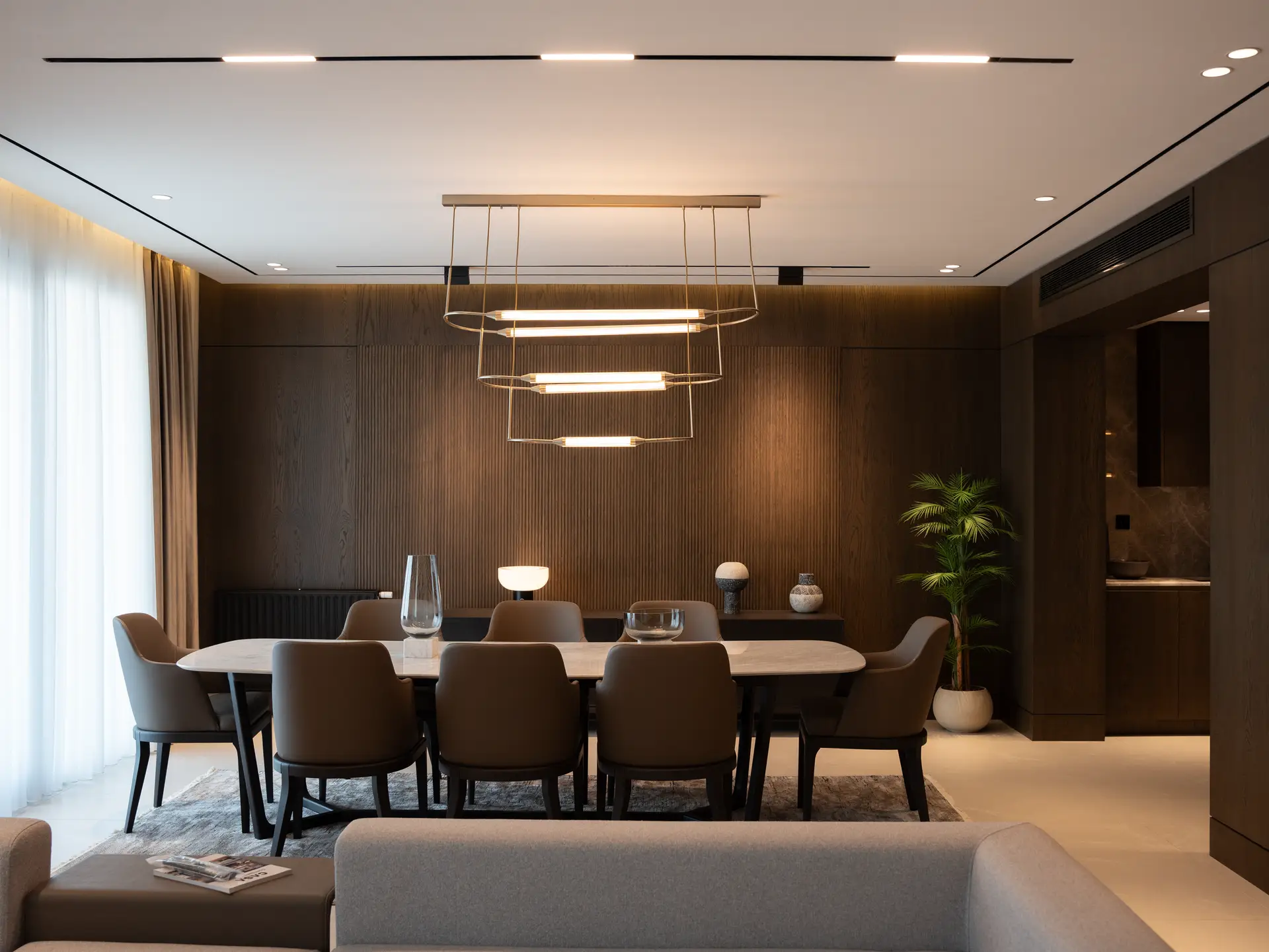 Contemporary dining and culinary wing with timber joinery and sculptural pendant lamps