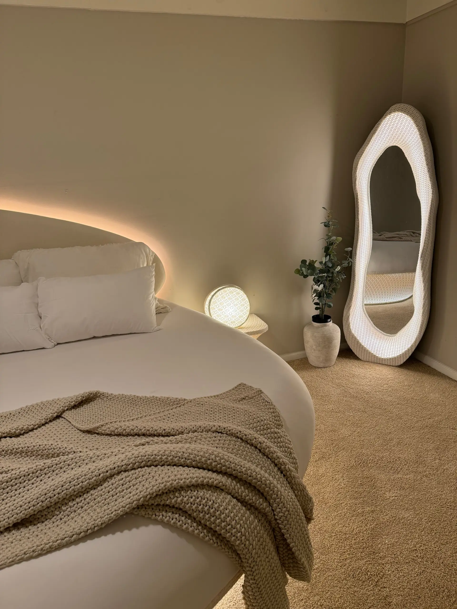 Warm ambient bedroom mirror reflection with soft natural linen and stone architectural details