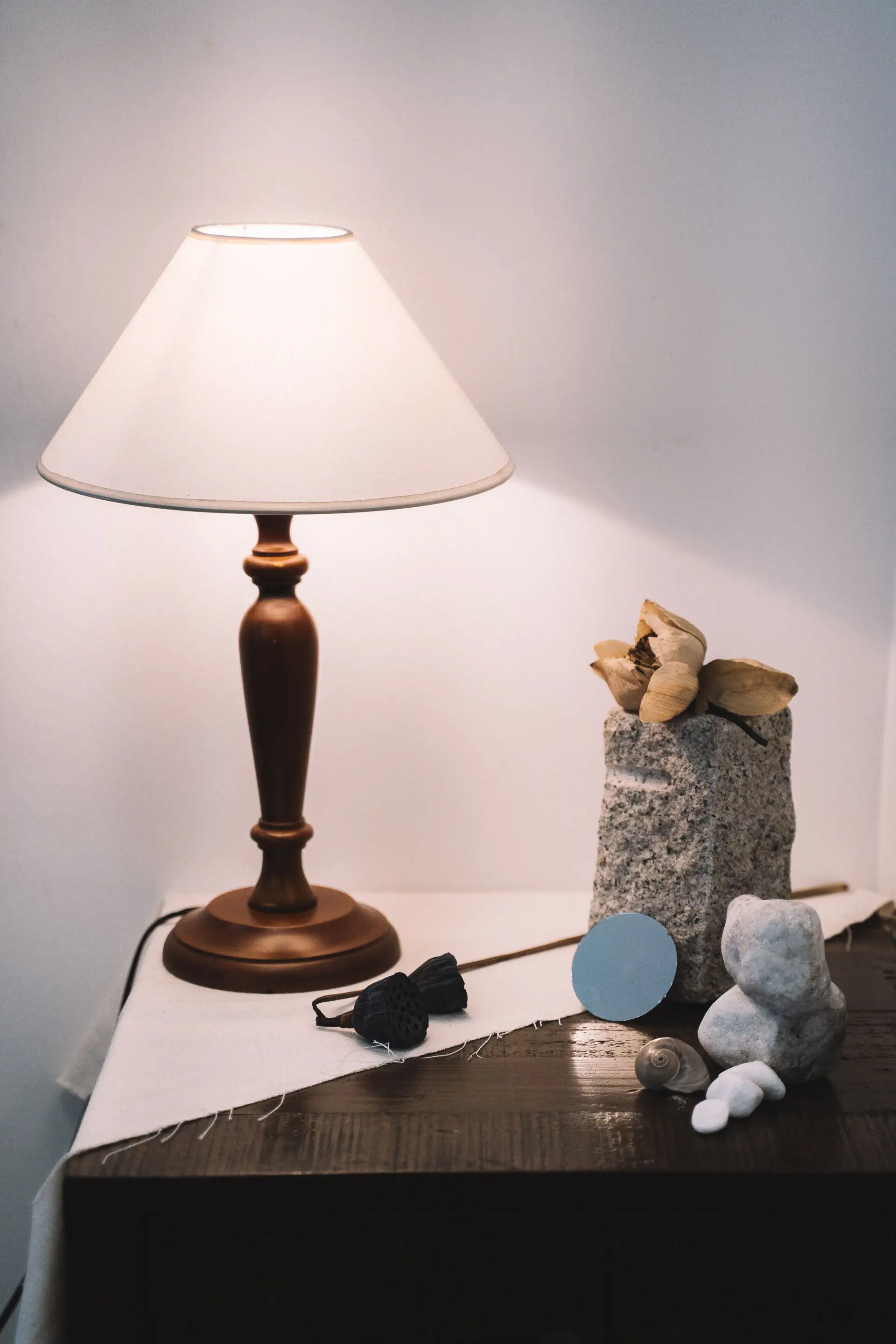 Natural carved stone vase and tactile organic textures curated for bespoke residential spaces
