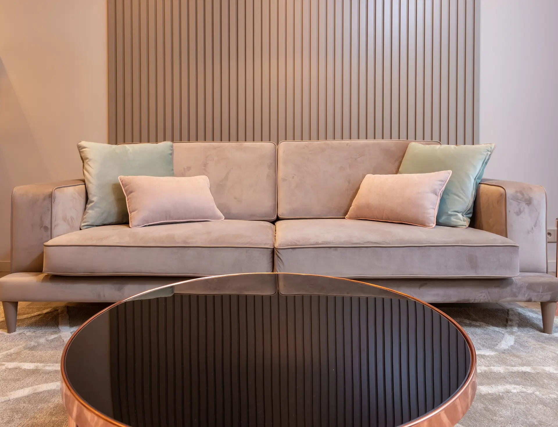 Intimate formal lounge featuring bespoke round travertine coffee table and low-slung seating