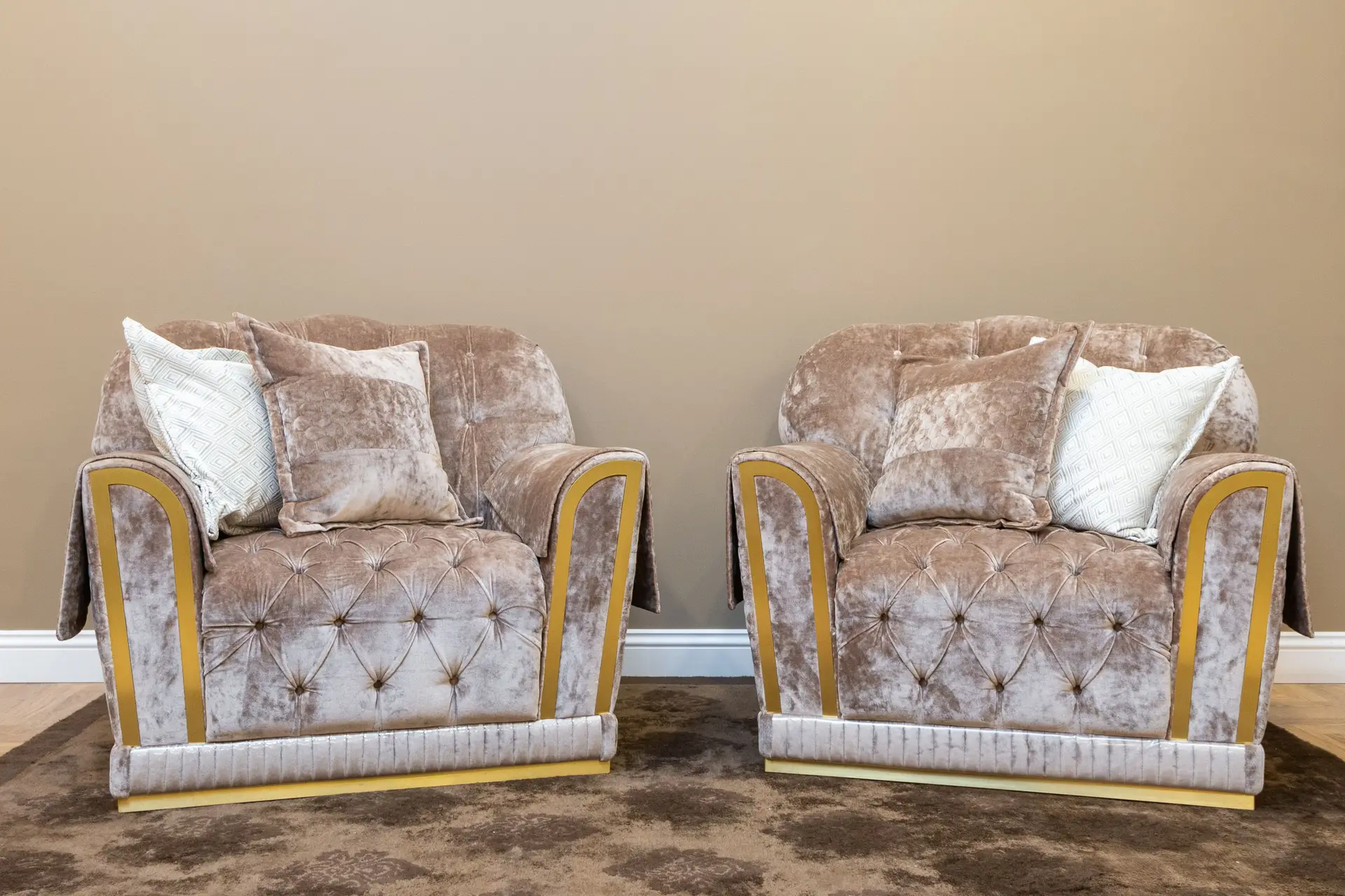 Pair of plush velvet armchairs in an uncluttered reading alcove